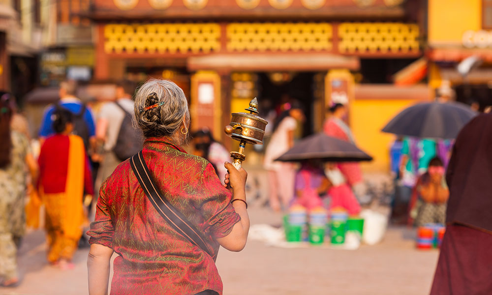 Woman spinning a prayer wheel
