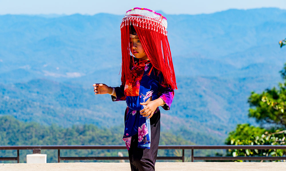 A colourful child posing for photographs